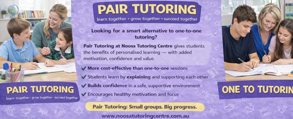 two students being tutored together looking happy