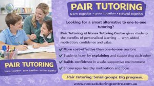 two students being tutored together looking happy